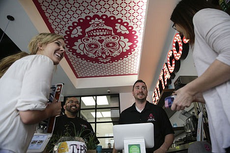 &lt;p&gt;Shop manager Jason Hurtado, center right, and kitchen manager Joseph Aranda, center left, take lunch orders from Brittany Keegan, left, and Kristen Thomas at U.S. Taco Co., which is owned by Taco Bell, in Huntington Beach, Calif., on Feb. 20.&#160;&lt;/p&gt;