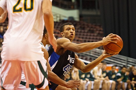 &lt;p&gt;Coeur d'Alene's Deon Watson passes the ball in the second half of state basketball action in Nampa.&lt;/p&gt;