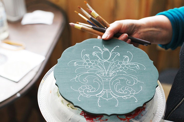 &lt;p&gt;Alice Brosten sketches a guide before she applies paint to her rosemaling pieces. Thursday, Feb. 28, 2013 in Bigfork, Montana. (Patrick Cote/Daily Inter Lake)&lt;/p&gt;