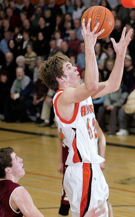 Flathead&#146;s Geoff Hogan drives past a Helena defender on the way to the basket during the first half of Thursday night&#146;s Western AA playoff game at Flathead High School. Craig Moore/Daily Inter Lake