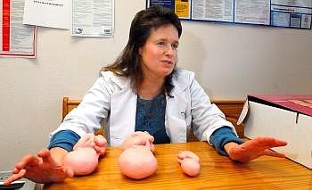 Hosanna Health Care owner Dr. Ann Bukacek describes the differences in development between a 20-week-old fetus, right; 30 weeks, center, and 26 weeks, left. &quot;The helplessness of the voiceless unborn is part of what spurs me on to protect them,&quot; Bukacek said. Allison Money/Daily Inter Lake