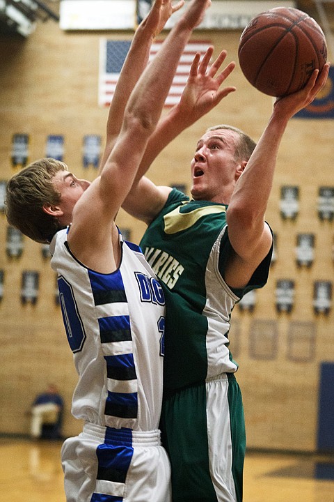 SHAWN GUST/Press

Zach Lehman, of St. Maries, goes to the basket in the first half against Sugar-Salem High School's Jason Hawkes Thursday.