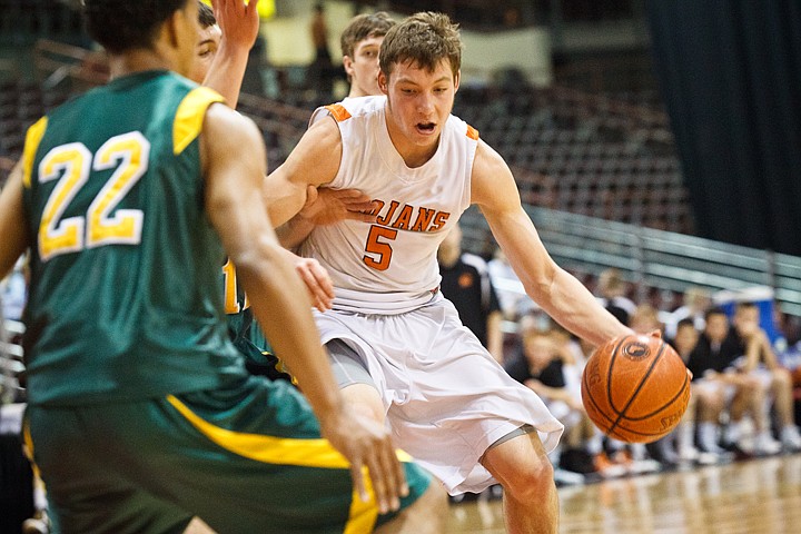 SHAWN GUST/Press

The Trojans' Connor Hill makes a move to the basket during state basketball action Thursday at the Idaho Center.