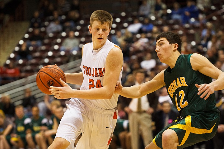 SHAWN GUST/Press

Michael Hill, guard for the Post Falls Troans, drives past Borah High's Braden Corpus in the second half.