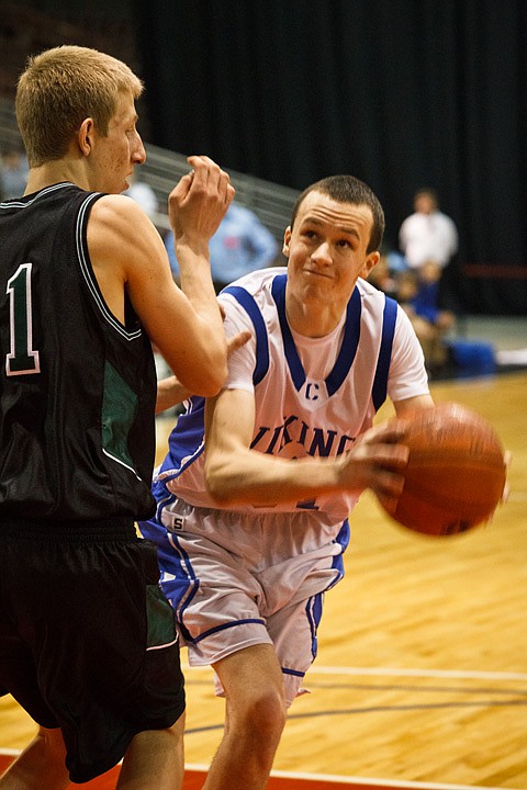 SHAWN GUST/Press

Ty Higbie, forward for the Coeur d'Alene Vikings, drives to the hoop against Eagle High School's Braiden Shaw in the first half.