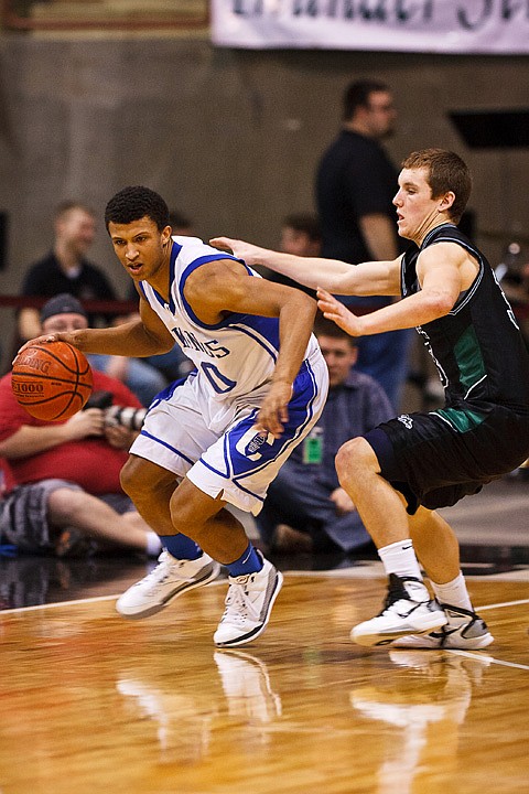 SHAWN GUST/Press

Coeur d'Alene's Deon Watson dribbles around Eagle defender  D.J. Dean during s
State 5A boys basketball action.