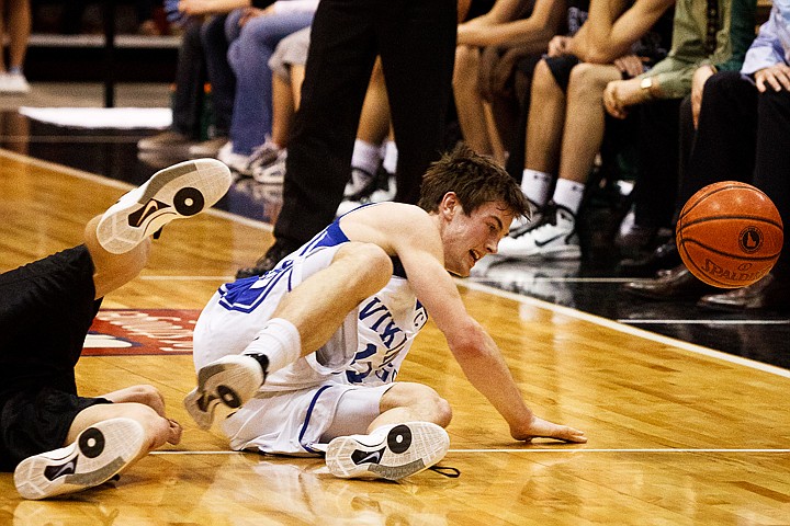 SHAWN GUST/Press

Chad Chalich falls to the floor while chasing a loose ball Thursday during State 5A boys basketball in Nampa.