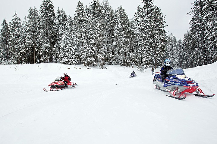 &lt;p&gt;Snowmobilers return from a six-hour trail ride Friday on the Fernan Saddle where they experienced three and four-foot-deep snow drifts along the route.&lt;/p&gt;