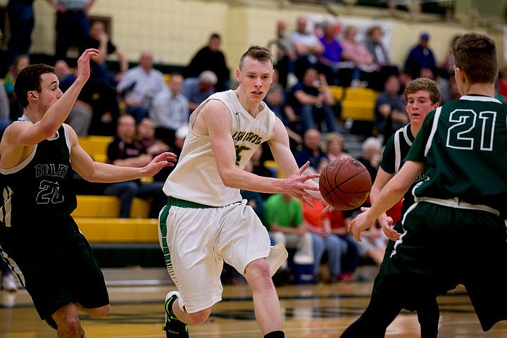 &lt;p&gt;Lakeland forward Andrew Knight passes to a teammate as Burley's Britton Garrard, left, and Paxtyn Bodily (21) defend at the first 4A state basketball state game on Thursday, March 3, 2016 at Borah High School in Boise. Burley defeated Lakeland 56-45.&lt;/p&gt;