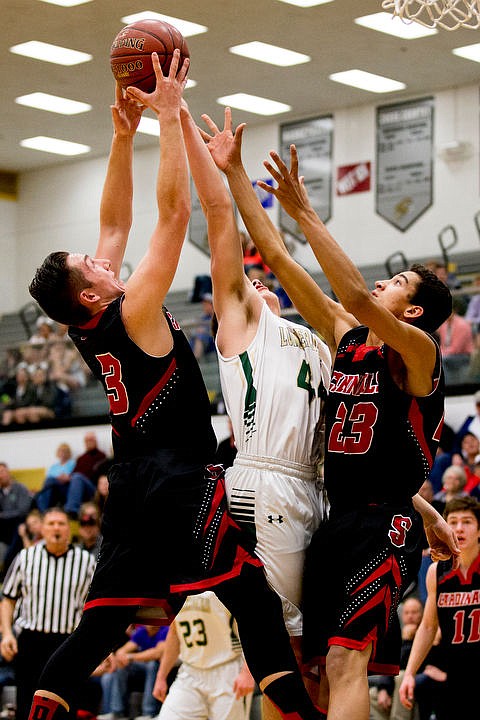 &lt;p&gt;St. Maries post Nate Masterson, center, fights for the ball with Soda Springs guard Josh Balls (3) and Henry Workman on Thursday, March 3, 2016 in the first 2A state game at Capital High School in Boise, Idaho. The Lumberjacks defeated the Cardinals 45-42.&lt;/p&gt;