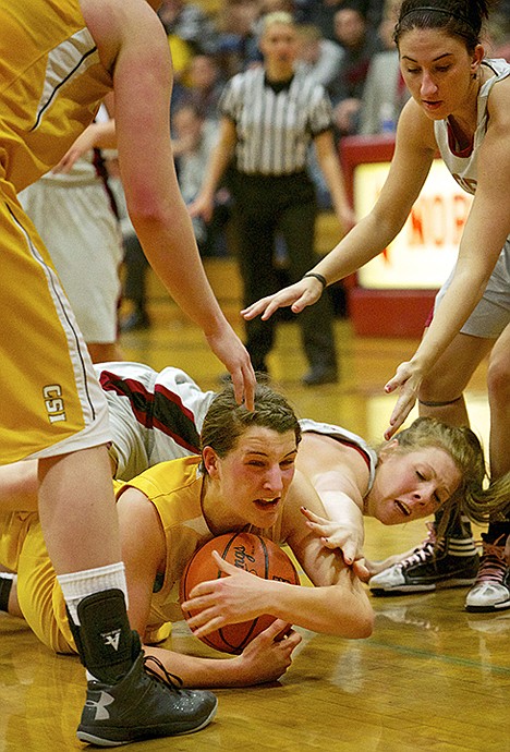 <p>North Idaho College's Hannah Love reaches to get to the ball being held by Julia Dufurrena from College of Southern Idaho.</p>