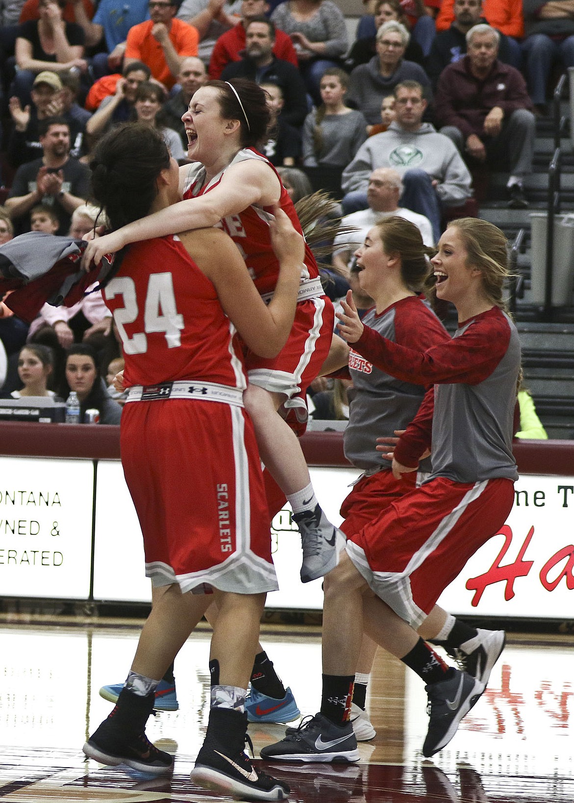 &lt;p&gt;Arlee's Shaylee Perry jumps into Alyssia Vanderburg's arms after the Scarlets won the divisional championship Saturday.&lt;/p&gt;