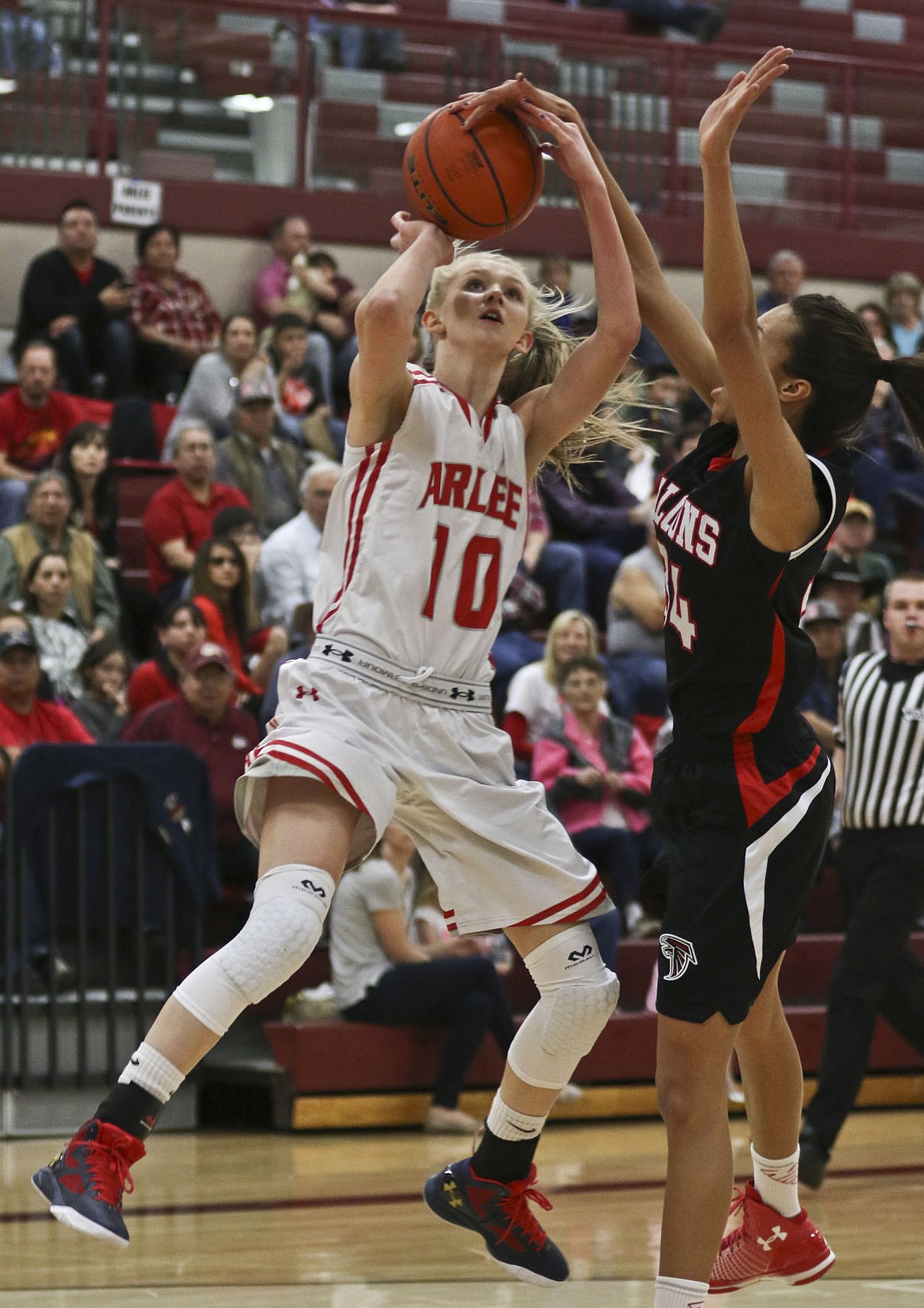 &lt;p&gt;Arlee's Carly Hergett puts up a shot around a Twin Bridges defender in the first round of the divisional tournament in Hamilton.&lt;/p&gt;