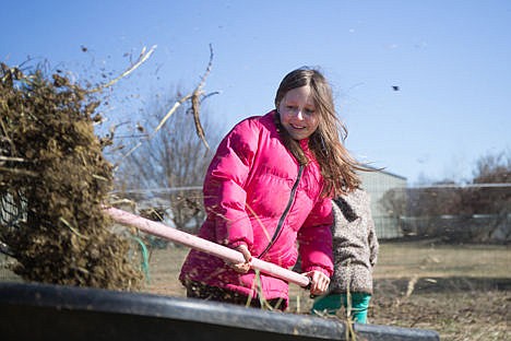 &lt;p&gt;Genelle Hageman, 7, smiles as she lifts a heavy pitchfork load of manure into a wheelbarrow. Cleaning up is part of what the kids get to do at the ranch.&lt;/p&gt;