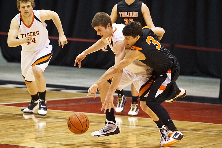 SHAWN GUST/Press

Damon Gonzales, of Post Falls, knocks the ball from Idaho Falls High School's Sean McCarthy during state basketball play in Nampa.