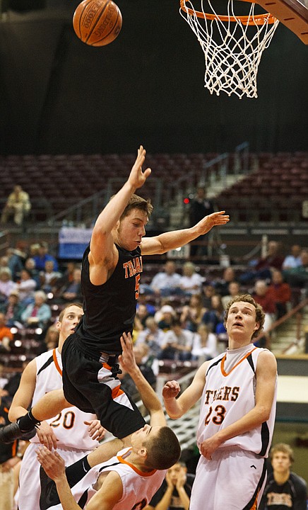 SHAWN GUST/Press

Post Falls High School's Connor Hill draws the charge by an Idaho Falls defender in the first half.