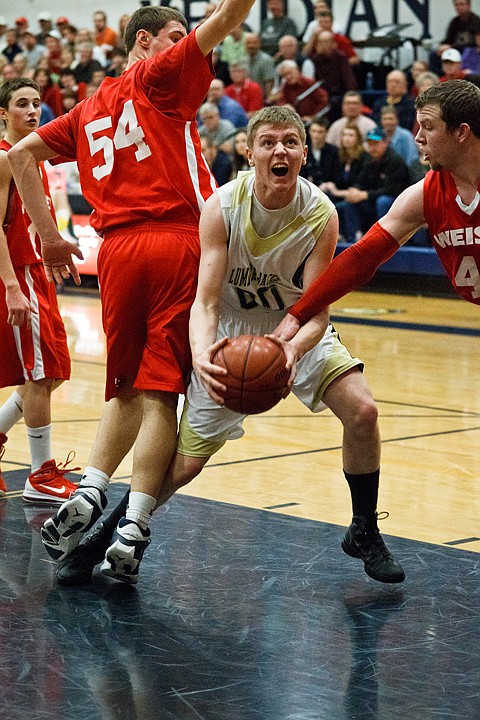 SHAWN GUST/Press

Warren Joiner, of St. Maries, is fouled by Wieser High's Spencer Chandler in the third quarter.