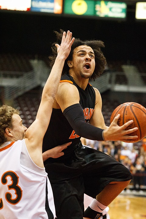 SHAWN GUST/Press

Post Falls guard Marcus Colbert drives to the hoop for a Trojans score in the boys state basketball tournament.