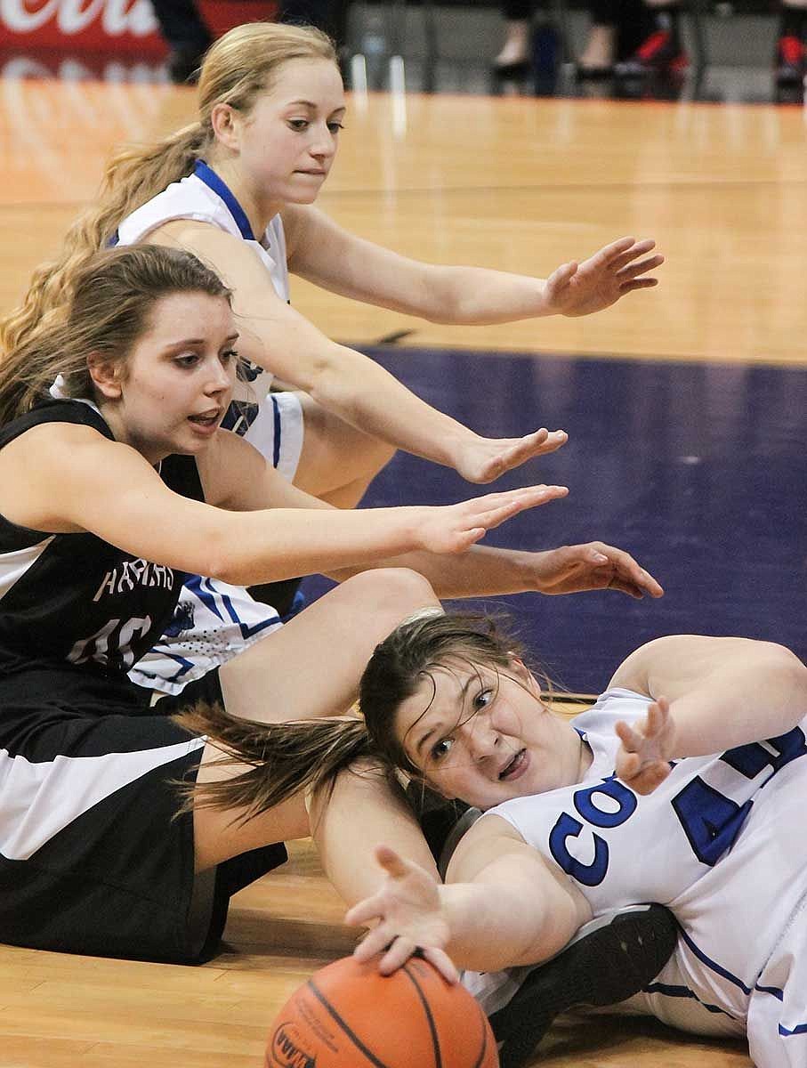 ACH's Brenna Oliver scrambles for a loose ball as Colton's Georgia Meyer tries to control the ball on the floor during the 1B state tournament Thursday at the Spokane Arena.