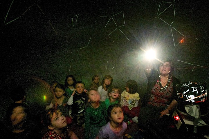 &lt;p&gt;JEROME A. POLLOS/Press Yulia Hall, a science teacher at the Hayden KinderCenter, highlights a constellation for a class inside an inflatable planetarium Tuesday. The &quot;StarLab&quot; was loaned to the school because three teachers participated in the i-STEM, (Idaho Science Technology Engineering Mathematics), Summer Institute last year and received specialized training on the astronomy program.&lt;/p&gt;