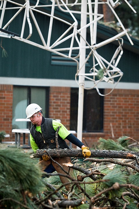 &lt;p&gt;SHAWN GUST/Press Devon Braithwaite, a climber for Grace Tree Service, hauls debris from a tree the company fell Monday after a portion of it crashed onto an outside gazebo structure on the North Idaho College campus in Coeur d'Alene. Minimal damage was reported.&lt;/p&gt;