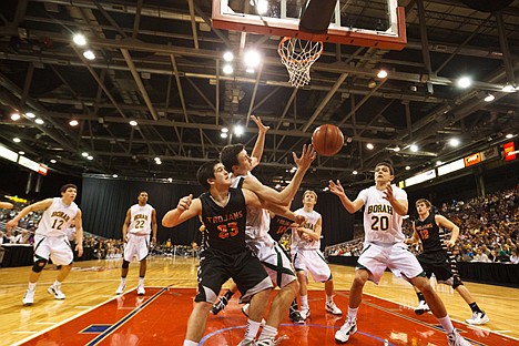 &lt;p&gt;The Trojans' Scott Benner is blocked out by Borah defenders while going for a second half rebound.&lt;/p&gt;