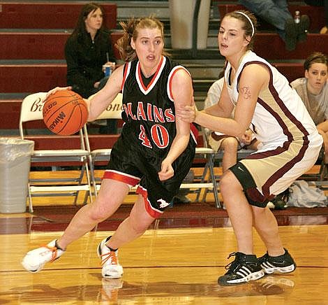 Plains Trotter Bethany Catalanello darts around Florence Lady Falcon Brook Zeiler at the 2008 Western B Girls Basketball Tournament at Hamilton. The Lady Falcons defeated the Trotters 49-28 in Thursday&#146;s game. The Trotters won the second game against the Thompson Falls Lady Hawks, but lost to Eureka Saturday, taking them out of the competition.