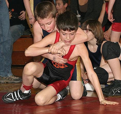 Little Guy wrestler Griffon Larsen of Thompson Falls tries to take the advantage on Chayton Lulack of Plains-Hot Springs during the 80-pound novice bout Thursday in Superior. Larsen won the match 9-5.