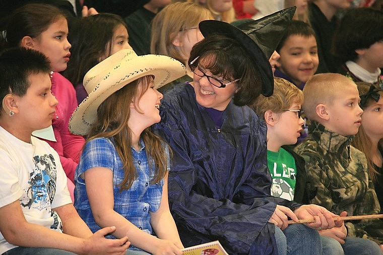 Dressed as their favorite book characters, Mrs. Chris Fischer and Morgan Polk share a laugh during the awards assembly Friday morning after Polk&#146;s name was picked for a book prize.