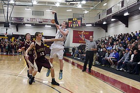 Bluehawk guard Josh Hojem watches his three-point attempt as a Falcon defender turns to box out for the rebound.