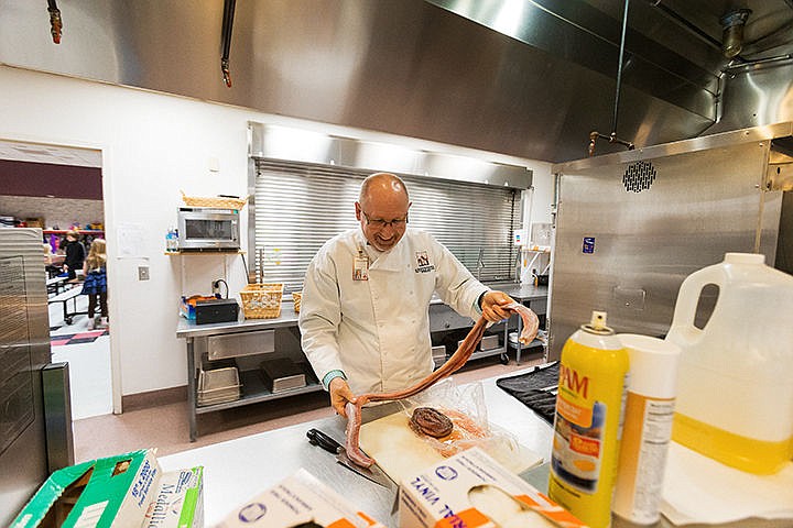 &lt;p&gt;William Rutherford, principal at Fernan Elementary, prepares rattlesnake in the school&#146;s kitchen on Tuesday for the upcoming Wild Game Feast fundraiser that will benefit their Science, Technology, Engineering and Math program. Tickets for the February 21 event at Avondale Golf Club are $75. For more information call 664-2659.&lt;/p&gt;