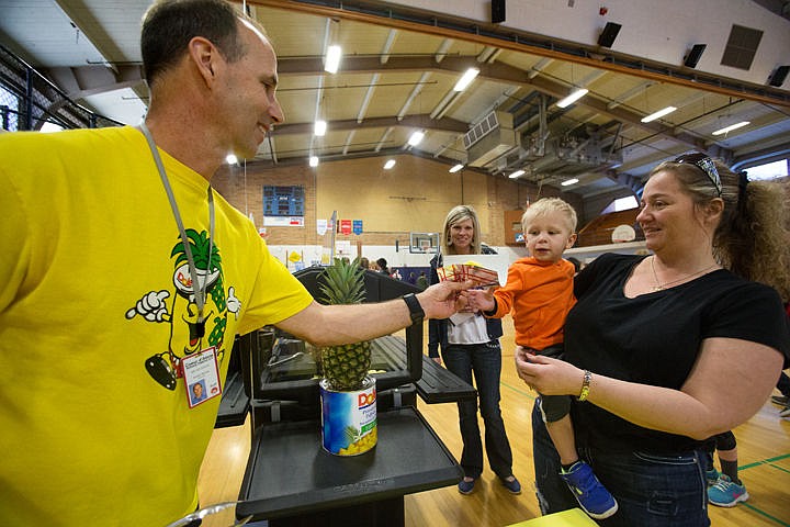 &lt;p&gt;Asher Garrett, 2, reaches for a slice of juicy pineapple from Ed Ducar, director of the Coeur d'Alene schools meal program, at the Health GPS event on Tuesday at Lakes Magnet Middle School. The event was held to educate children in the community on nutrition, exercise, bike safety and more.&lt;/p&gt;