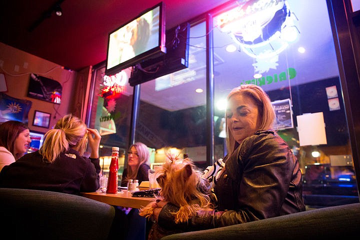 &lt;p&gt;Lauri Carlson of Coeur d'Alene sits with her Yorkshire Terrier, Kozy, at Crickets Restaurant on Tuesday night to watch the Westminster Kennel Club Dog Show. Carlson takes her dog every year to Cricket's dog show viewing party.&lt;/p&gt;