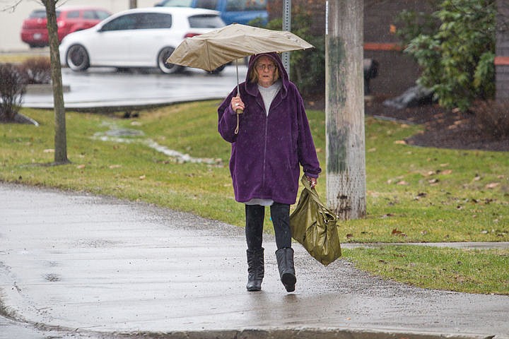 &lt;p&gt;Sue Coon braves the rain with her umbrella on her walk home on Monday afternoon in Coeur d'Alene.&lt;/p&gt;