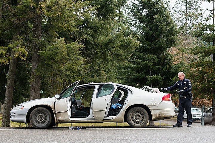 &lt;p&gt;Cpl. Michael Lininger, with the Idaho State Police, conducts a search of a vehicle after a traffic stop resulted in a drug arrest Tuesday on the Sherman Avenue exit ramp of Interstate-90 in Coeur d&#146;Alene. After the driver gave a false name, it was discovered the male&#146;s license was suspended. Upon further investigation, methamphetamines, syringes, a pipe and other drug paraphernelia were found in the vehicle.&lt;/p&gt;