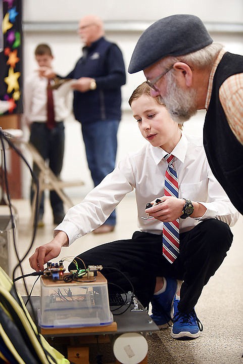 <p><strong>Luke Ritzdorf</strong>, a seventh grader at Kalispell Middle School, explains his project to volunteer judge Paul Watson of Columbia Falls. Ritzdorfs project was titled, Building an Autonomous Water-quality Measurement System.</p><div> </div>