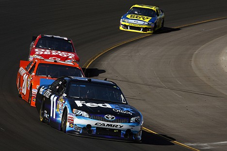 &lt;p&gt;Denny Hamlin (11) heads through a turn in front of Joey Logano (20), Tony Stewart and Matt Kenseth, rear, during the NASCAR Sprint Cup Series race in Avondale, Ariz., on Sunday.&lt;/p&gt;