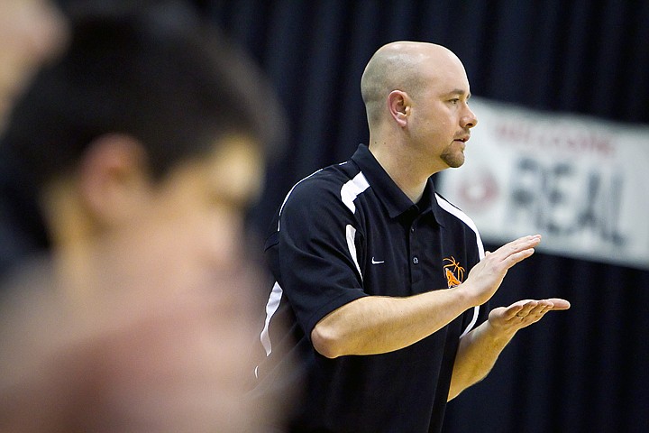 &lt;p&gt;Post Falls High's coach Mike McLean cheers on his team as they take the floor for the second half of the Trojan's tournament opener against Vallivue High at the state 5A championships Thursday.&lt;/p&gt;