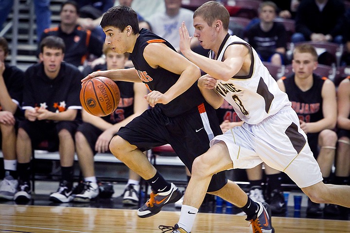 &lt;p&gt;Post Falls High's Damon Gonzales speeds past Drew Osburn from Vallivue High during the second half of the Trojan's tournament opener at the state 5A championships Thursday.&lt;/p&gt;