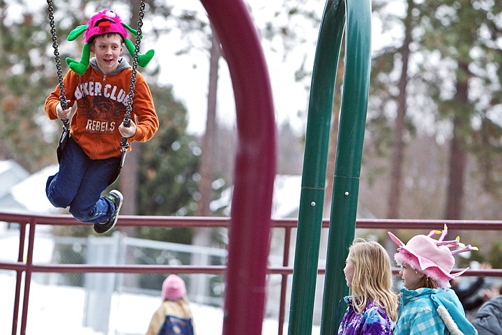 &lt;p&gt;JEROME A. POLLOS/Press C.J. Caruso, 9, swings through the air with his Seuss-inspired crazy critter hat flowing in the wind Friday as his classmates wait for him at Fernan Elementary. Students celebrated Dr. Seuss' 103rd birthday at school throughout Coeur d'Alene various activities including with pajama days, games based on Seuss' books, and green eggs and ham for breakfast and roast &quot;beast&quot; for lunch.&lt;/p&gt;