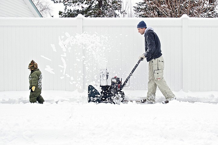 &lt;p&gt;JEROME A. POLLOS/Press Gabe Deuling, 2, clears a path for his dad Nick Deuling who snowplows the sidewalk by their Coeur d'Alene home Wednesday following the overnight storm that dropped a fresh blanket of snow.&lt;/p&gt;