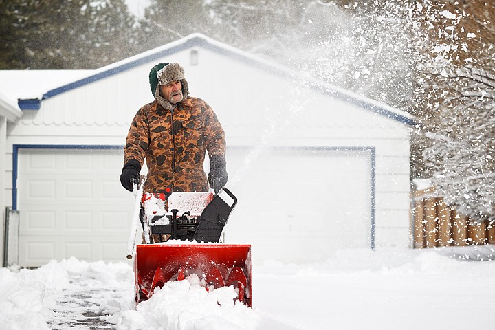 &lt;p&gt;SHAWN GUST/Press Don Weagley removes snow from his driveway Wednesday at his Coeur d'Alene home near Canfield Mountain. Several inches of snow fell in the overnight hours, blanketing the area.&lt;/p&gt;