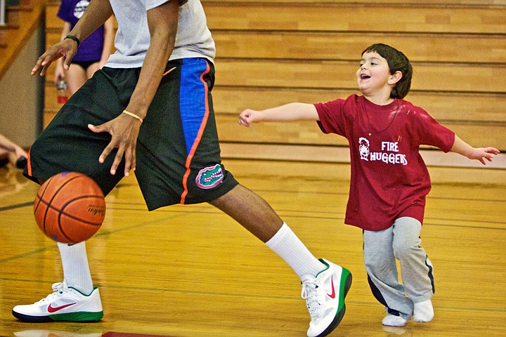 &lt;p&gt;JEROME A. POLLOS/Press Thomas Reed gives chase to North Idaho College basketball player Cole Luckett during a field trip to the college's gymnasium Tuesday. Reed and his fellow classmates from NIC's Children&#146;s Center visited the basketball team for a &quot;scrimmage&quot; that evolved into the students chasing the basketball players around the gym. Earlier in the semester the children visited the basketball team and decided to come up with their own basketball team. They developed team jerseys with their own numbers, voted on colors and named themselves the Fire-Huggers.&lt;/p&gt;