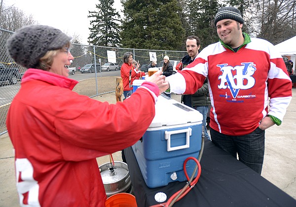 &lt;p&gt;Allison McCarthy of the Flathead Flames Women&#146;s League serves up a glass of beer to Henry Roberts of Whitefish on Saturday afternoon at the Brewers Cup Hockey Challenge and Brewfest at Woodland Park in Kalispell. Proceeds from the event will benefit the Flathead Valley Hockey Association.&lt;/p&gt;