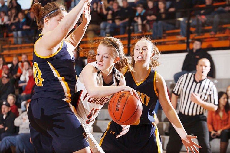 &lt;p&gt;Flathead senior Dani Davis (11) looks to pass the ball under heavy defensive pressure by two Missoula Big Sky players.&lt;/p&gt;