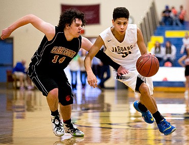 <p>Genesis Prep guard Elijah Schreibeis drives up-court past Clark County guard Payton Shenton at the 1A Division II state third place game on Saturday at Caldwell High School in Caldwell, Idaho. The Jaguars defeated the Bobcats 57-30. PURCHASE PHOTO: www.cdapress.com/photos</p>
