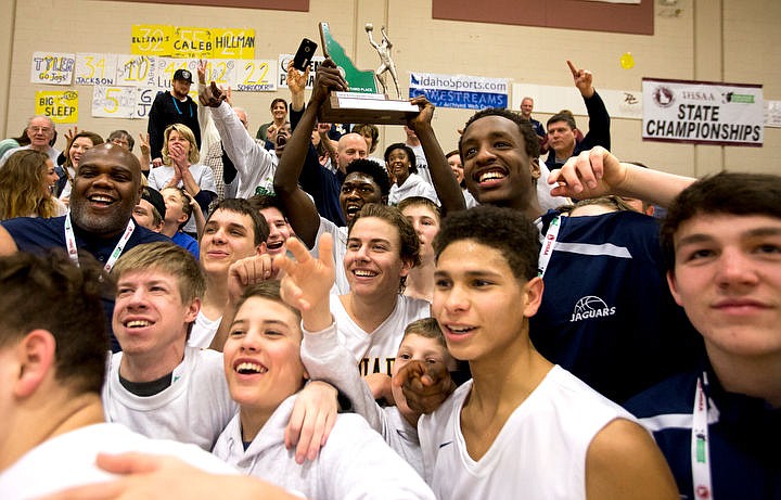 &lt;p&gt;Genesis Prep forward Jackson Ebune holds the 1A Division II third place trophy over his head as he celebrates with his team and their fans after defeating Clark County at the 1A Division II state third place game on Saturday at Caldwell High School in Caldwell, Idaho. The Jaguars defeated the Bobcats 57-30. PURCHASE PHOTO: www.cdapress.com/photos&lt;/p&gt;