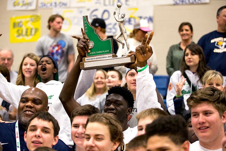 &lt;p&gt;Standing next to his head coach Marsell Colbert at left, Genesis Prep forward Jackson Ebune holds up the 1A Division II third place trophy after Genesis defeated Clark County at the 1A Division II state third place game on Saturday at Caldwell High School in Caldwell, Idaho. The Jaguars defeated the Bobcats 57-30. PURCHASE PHOTO: www.cdapress.com/photos&lt;/p&gt;