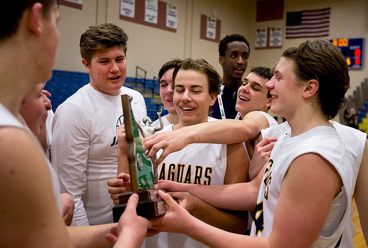 &lt;p&gt;JAKE PARRISH/Press Genesis Prep players touch the 1A Division II third place trophy after defeating Clark County at the 1A Division II state third place game on Saturday at Caldwell High School in Caldwell, Idaho. The Jaguars defeated the Bobcats 57-30. PURCHASE PHOTO: www.cdapress.com/photos&lt;/p&gt;