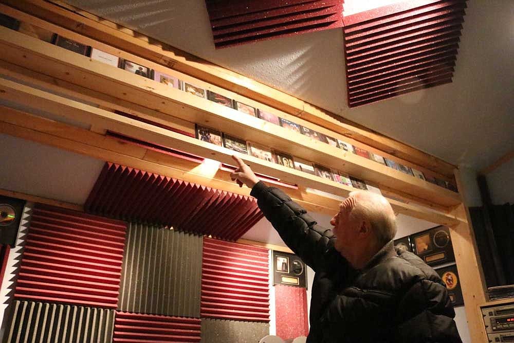 &lt;p&gt;Chuck Seward points to CDs of artists he has recorded in his professional audio recording studio just outside Superior.&lt;/p&gt;